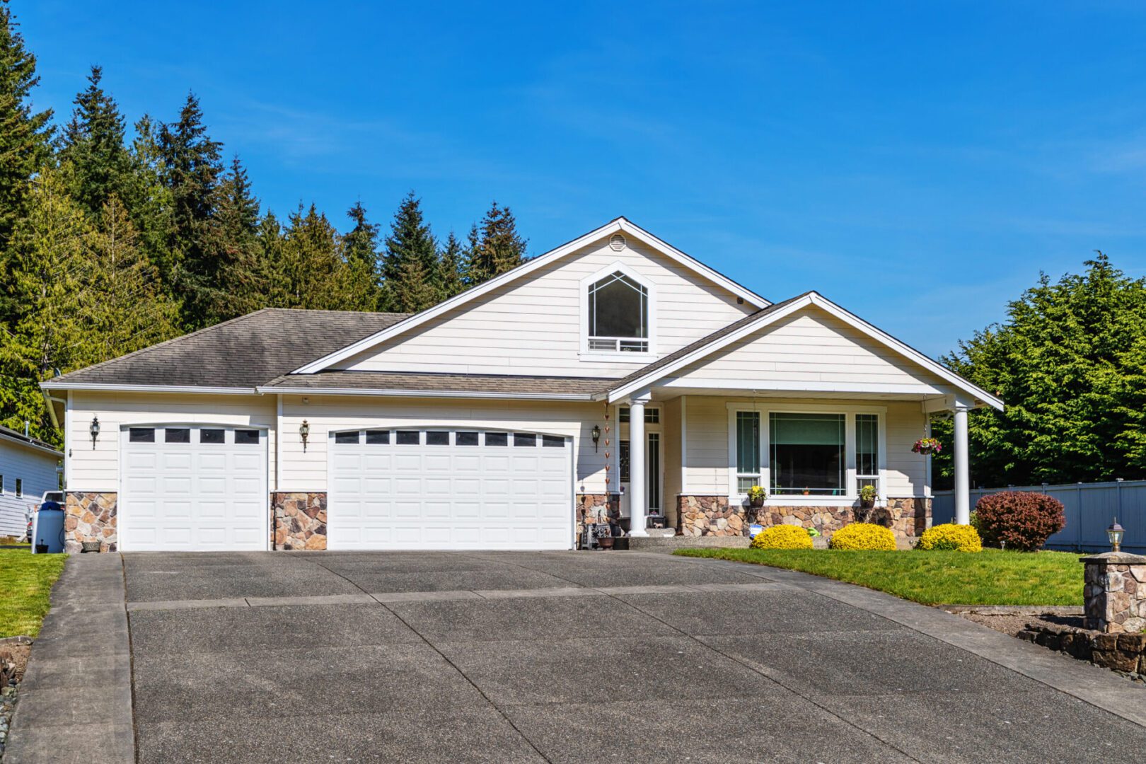 White suburban house with two garages.