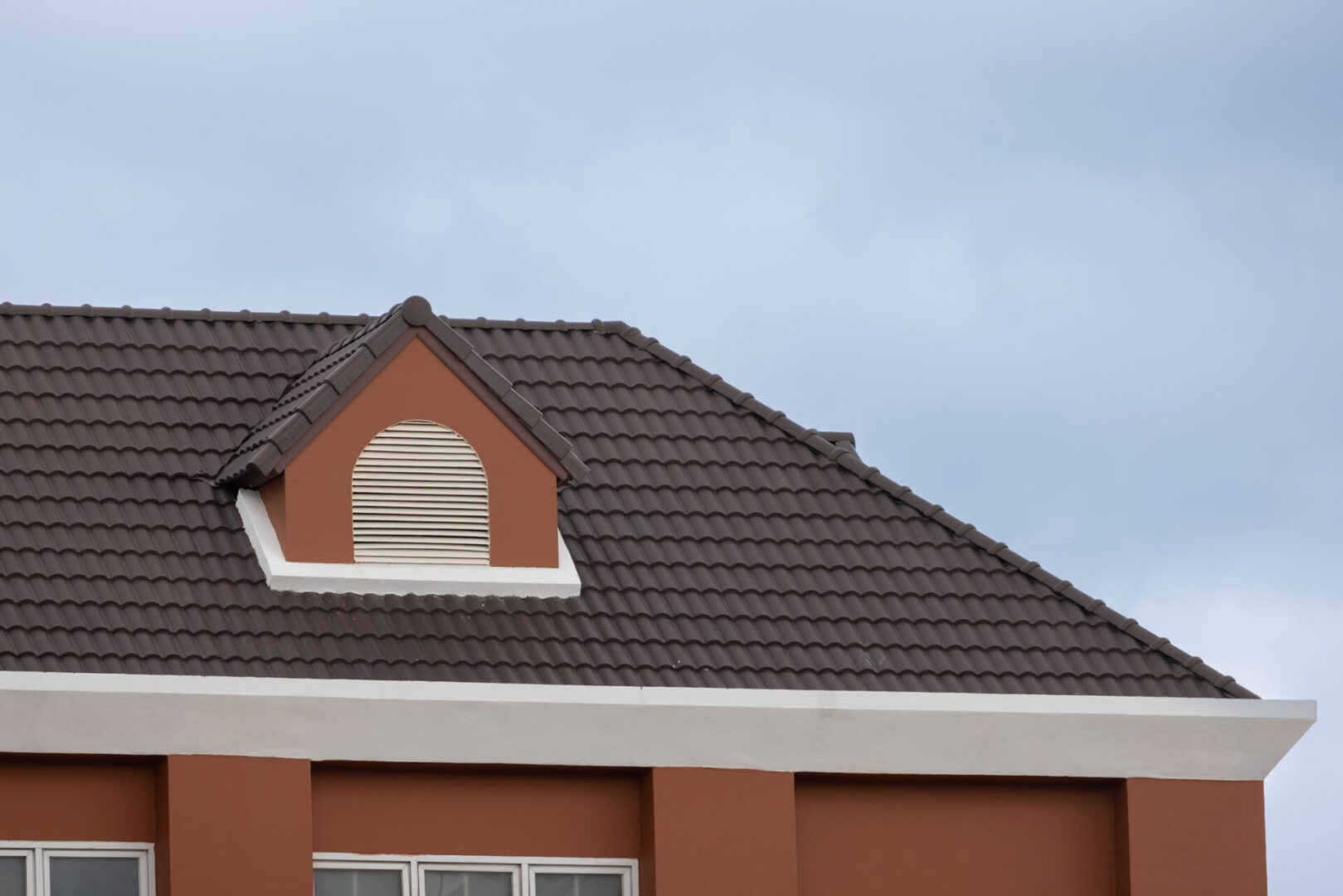 Brown tiled roof against sky