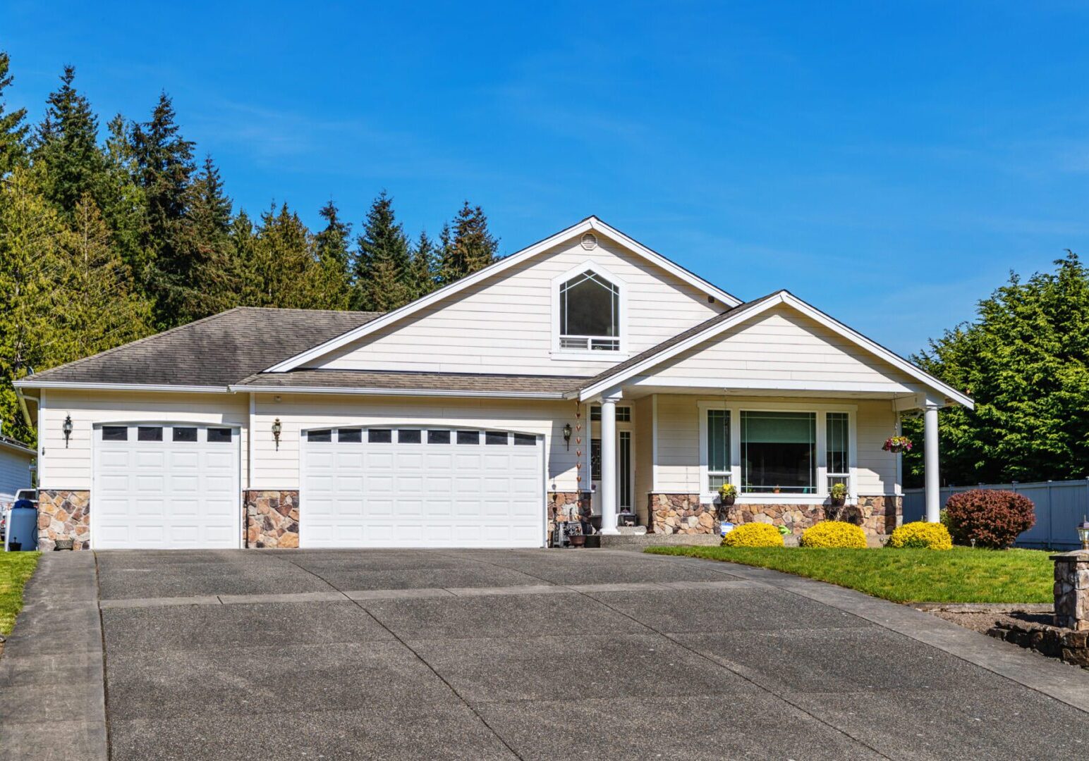 White suburban house with two garages.
