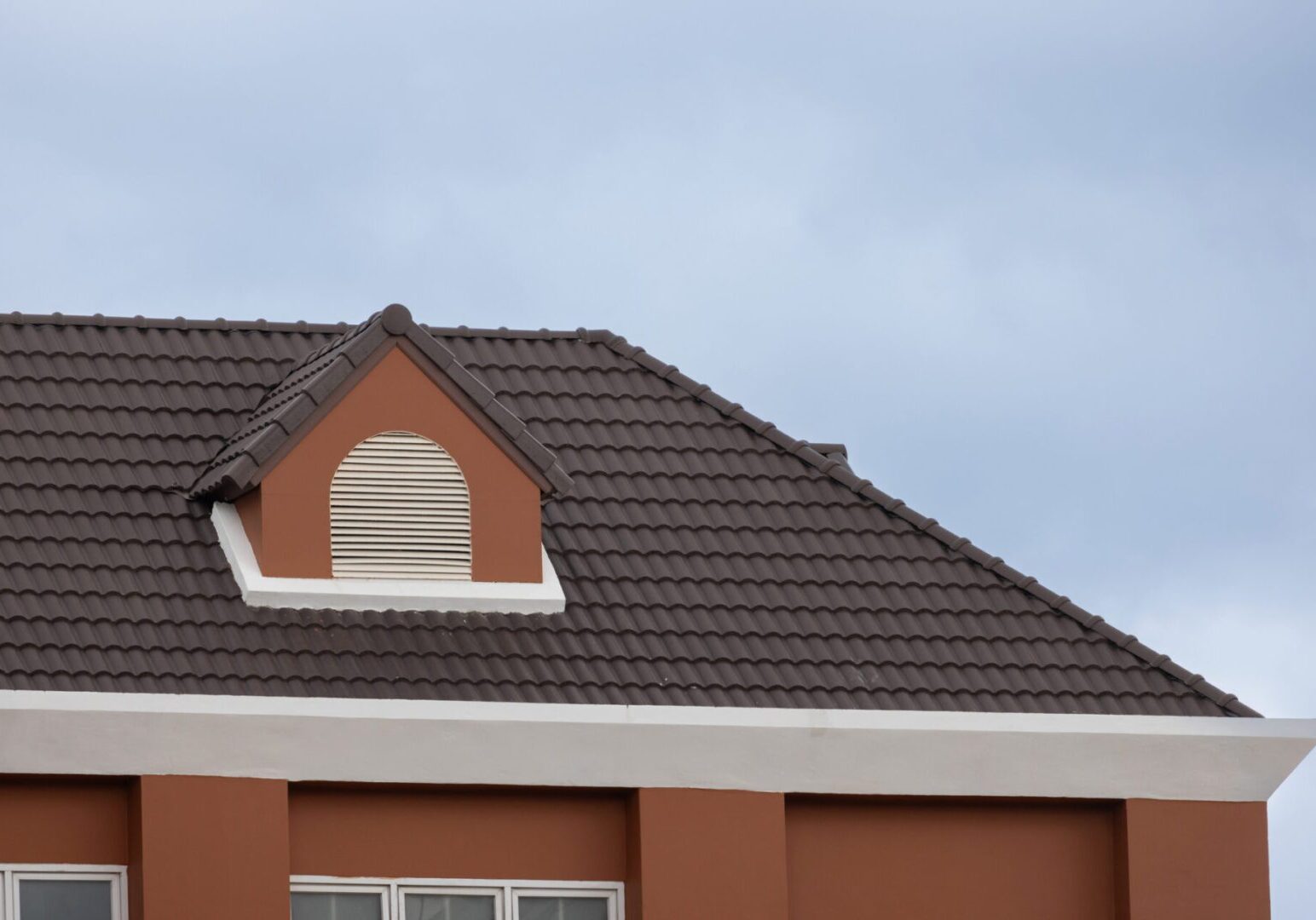 Brown tiled roof against sky